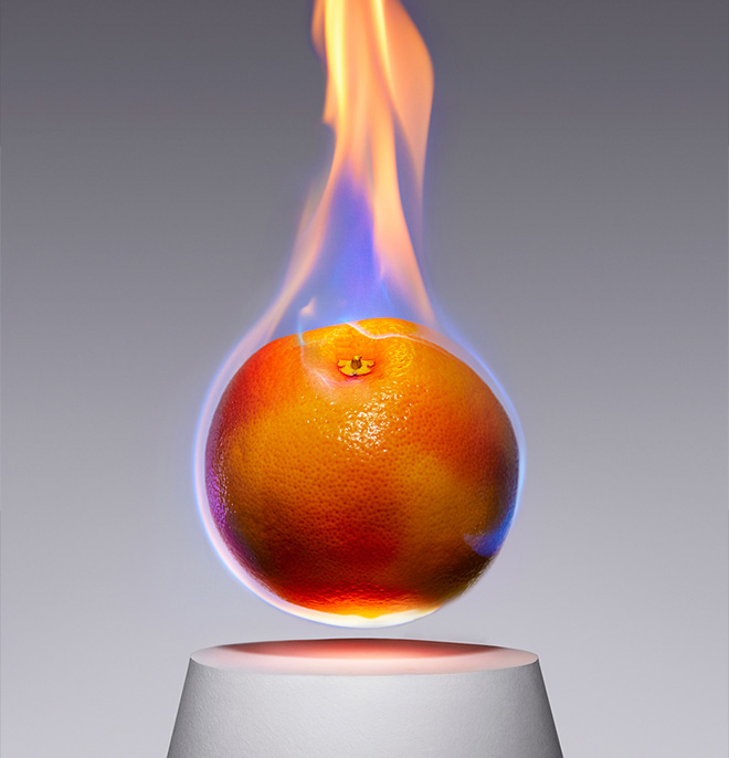 A fiery blaze of flames engulfs a grapefruit